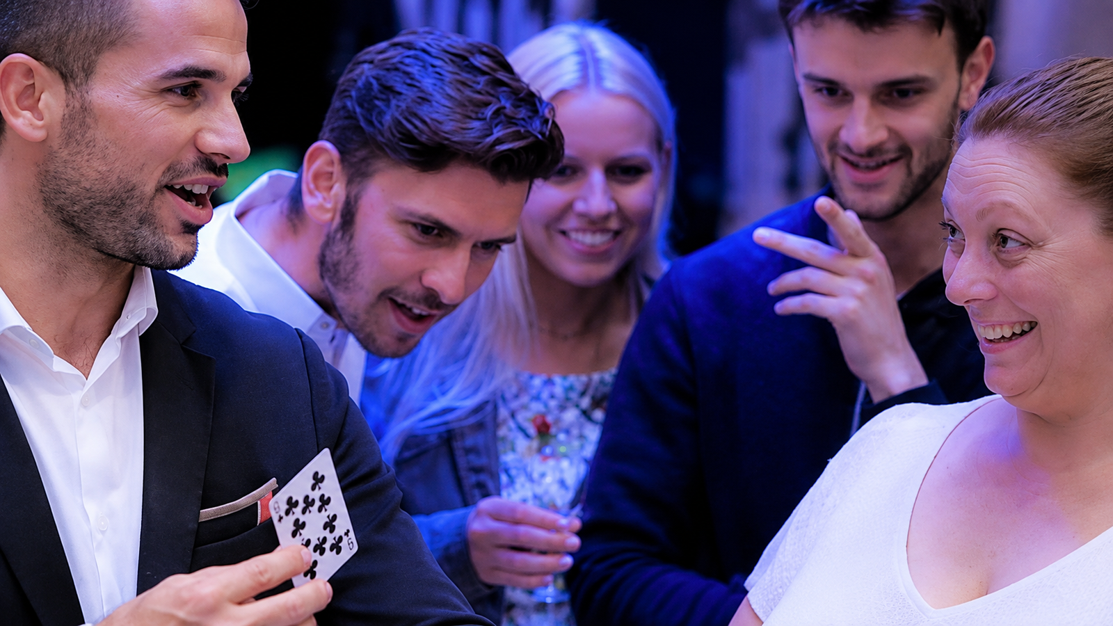 Guests enjoying close-up magic once the party is properly going