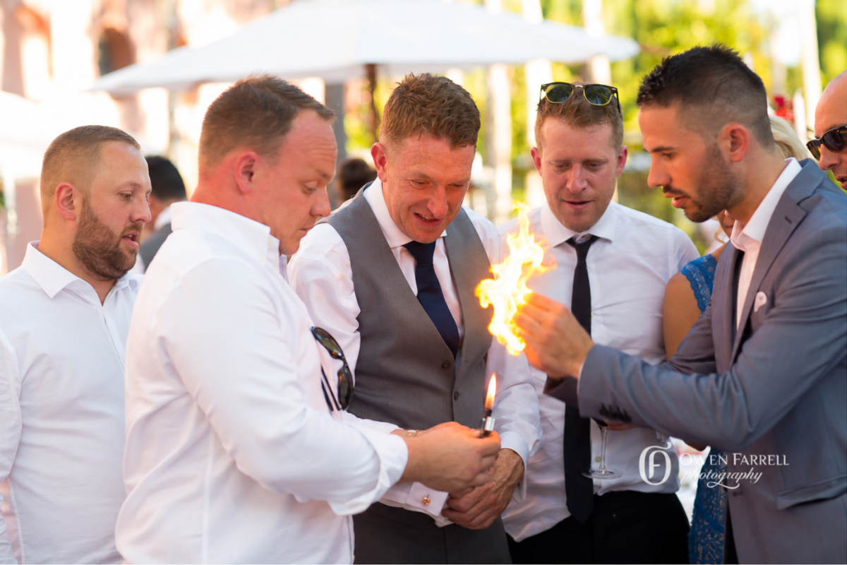 Guests entertained by close-up magic once plates have been cleared at a private party