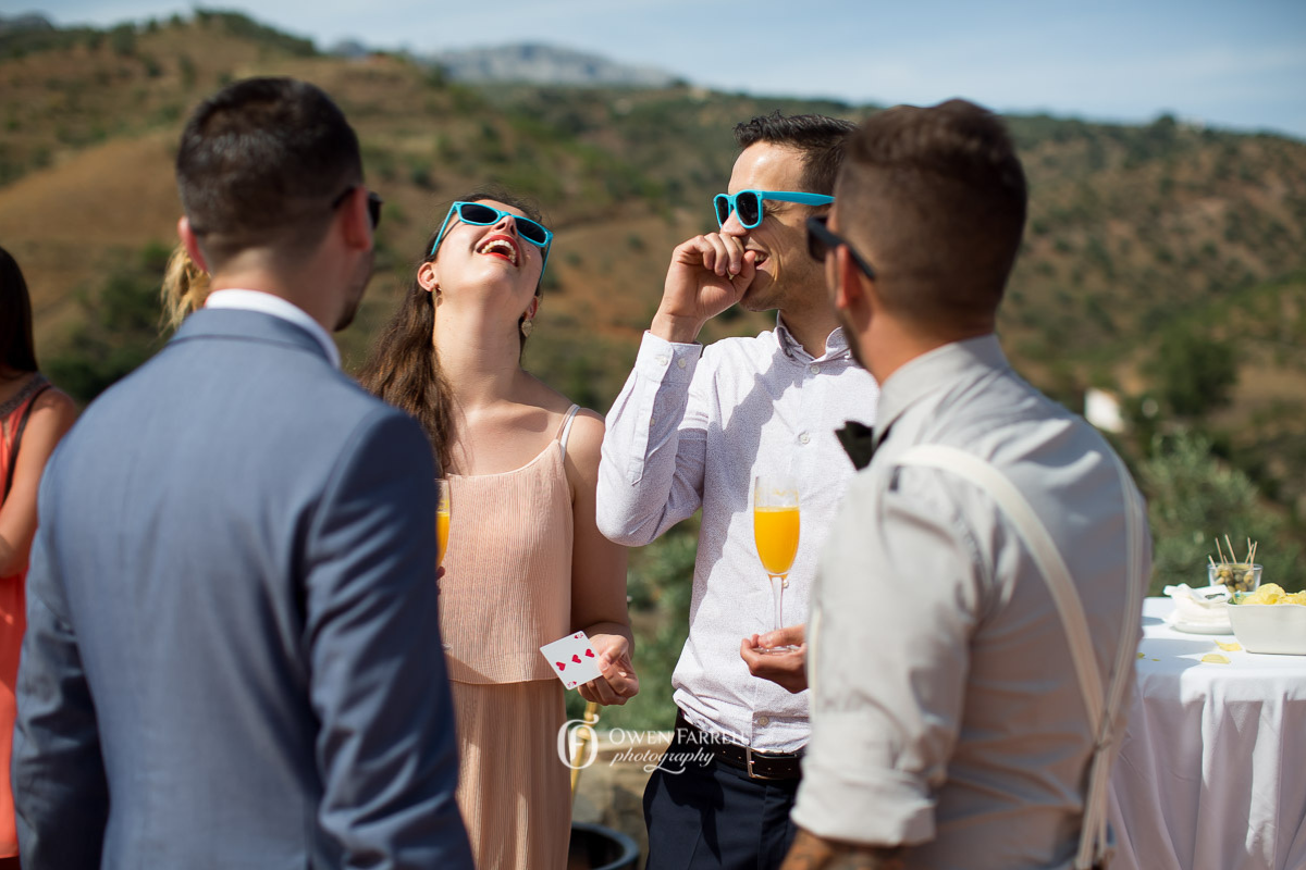Guests mingling with close-up magic as they arrive at a private party